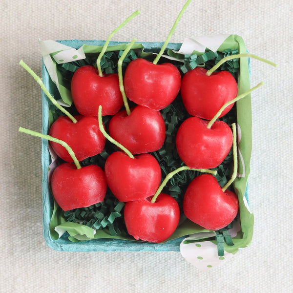 Beeswax Cherry Birthday Candles up close, showing realistic glossy red cherry shape and stem wick, handmade in Los Angeles by Happy Organics